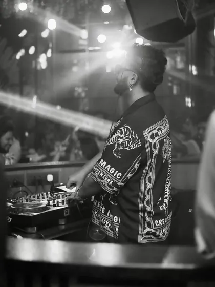 A moody black and white shot from behind the decks.