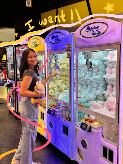 I want them all. The claw machine struggle is real, but at least we got one cute prize. The doodles capture the arcade excitement.