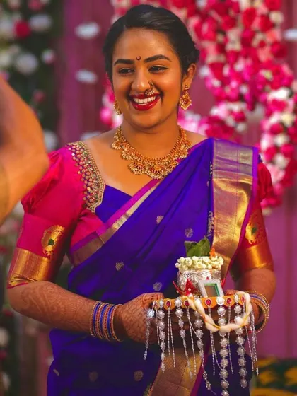 I love playing with vibrant, happy colors. This bride is glowing in a royal blue Kanjeevaram saree with a contrasting bright pink puff-sleeve blouse for one of her pre-wedding functions.