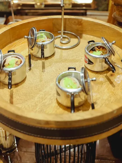 Our Chicken Malai Tikka is served in adorable miniature pressure cookers, a playful presentation that always delights guests at corporate events and parties.