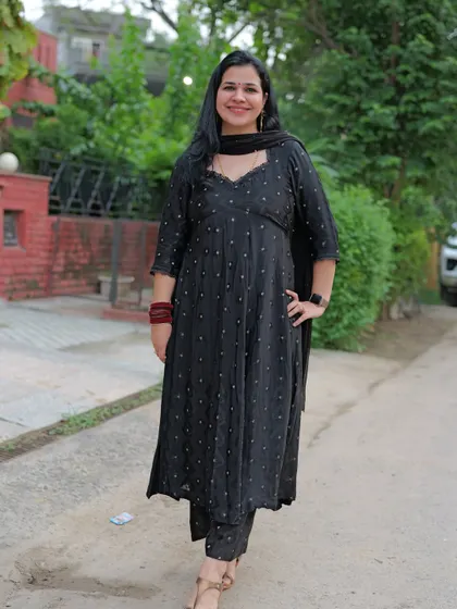 A closer look at a custom-stitched black suit with a beautiful sweetheart neckline, created from fabric. This design is simple, elegant, and very versatile.