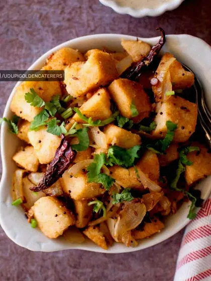 Our Fried Idli is a tasty appetizer where steamed idli cubes are tossed with onions, spices, and fresh cilantro. It's a creative and popular dish for any event.