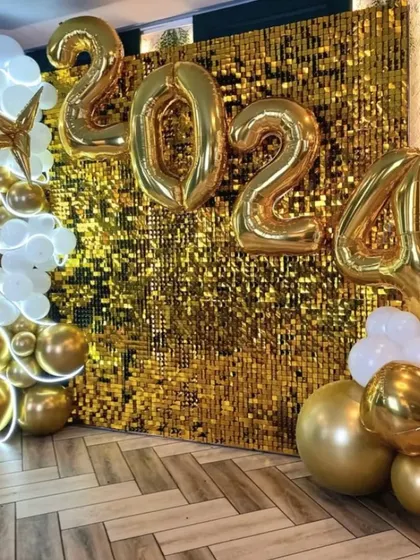 Ringing in the New Year calls for something spectacular. This 2024 party backdrop combines a dazzling gold sequin wall with large foil number balloons and a cascade of metallic gold and white balloons for a truly celebratory look.