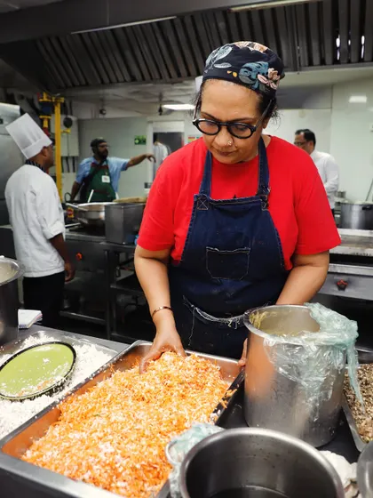 Here I am, in my element, preparing a large batch of a carrot dish for a catering event. There's nothing better than using your hands to create and elevate a dish.