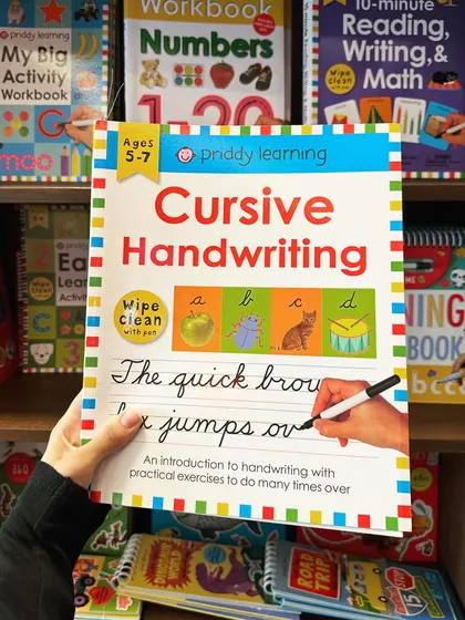 A "Cursive Handwriting" workbook, another example of the educational materials available in our store for skill development.