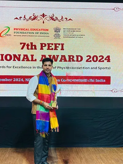 A solo shot with my award at the ceremony. This award is not just for me, but for every player, parent, and coach who is part of the IB Sports Academy family.