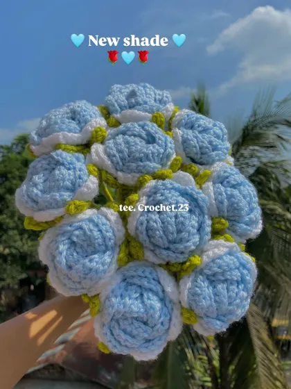 A beautiful new shade of light blue roses, held up against the sky to show their lovely color.