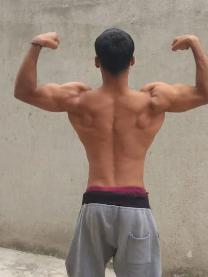 A strong back is the foundation of a strong body. This pose highlights the V-taper and muscle definition achieved through our pull-day workouts.