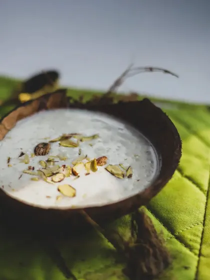 A close-up of a traditional Indian dessert, garnished with slivered almonds. We cover sweets and festival foods in our courses.