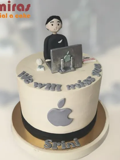 A cake for the ultimate Apple enthusiast. This design features the Apple logo, a figurine working on a Mac, and the message "We will miss you," making it a perfect farewell cake for a tech colleague.