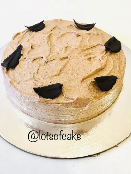 My butterscotch cake with a simple, rustic chocolate frosting and decorated with a few chocolate leaves.