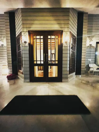 The main entrance sets the tone for the entire home. This is a custom double-leaf door made from solid teak wood, featuring beveled glass panels and all-concealed hardware for a clean and sophisticated look.