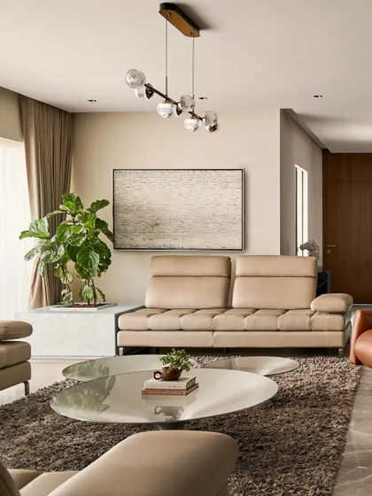 This living room was designed to be versatile, perfect for hosting business meetings or a gathering of close friends. The arrangement of the leather sofas and recliner creates a comfortable and conversational setting.
