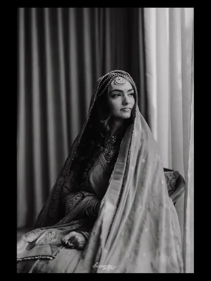A moody and classic black and white bridal portrait by the window.