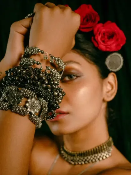An artistic portrait from the 'INARA' series. The focus here was on the intricate details of the silver jewelry, using dramatic lighting and a close-up frame to create a moody, intimate portrait that highlights the craftsmanship of the accessories.