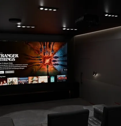 A view of my 'Project Eclipse' design, where the massive screen dominates the front wall. The surrounding speakers are perfectly placed for optimal sound, and the dark walls ensure maximum contrast.