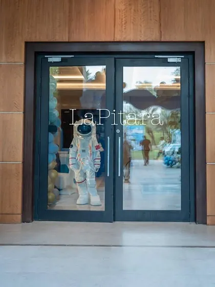 The entrance to the indoor party area, flanked by illuminated frames with space-themed graphics.