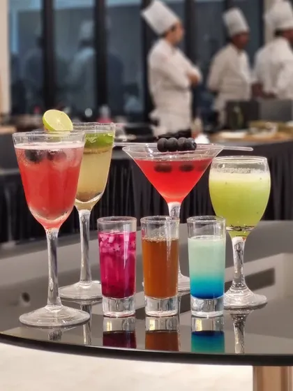 A vibrant collection of our signature mocktails and shooters. This image showcases the wide variety of colours, glassware, and styles we offer, from tall coolers to small, potent shots.
