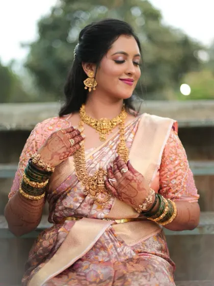A beautiful bride in her traditional attire, her hands adorned with my henna work, showcasing the complete look.