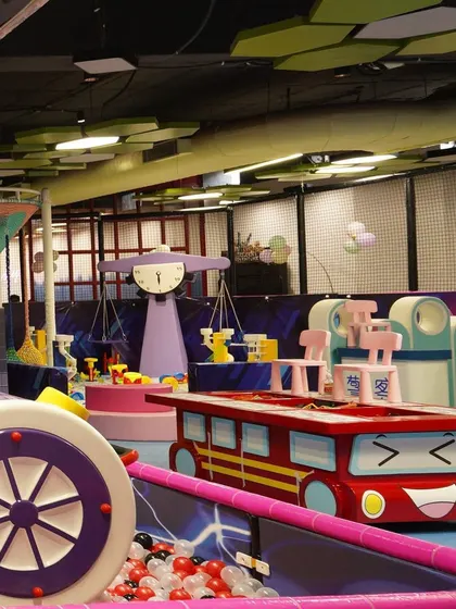 A glimpse of our colorful and whimsical toddler play area, featuring fun car-themed tables and other engaging structures.