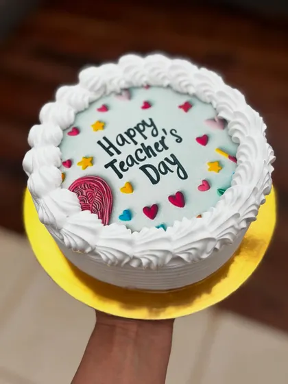 A sweet and simple cake for Teacher's Day. The design features piped buttercream borders and colorful heart and star sprinkles.
