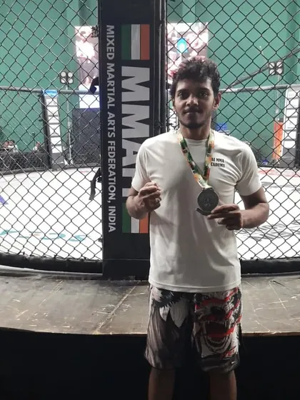 With my silver medal at the BJJ Nationals in Mumbai, standing in front of the cage.
