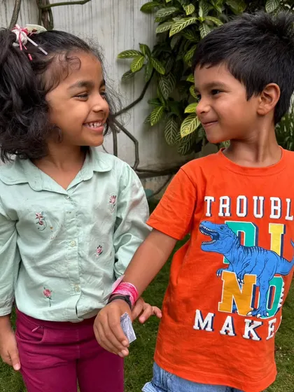 A shared smile and a handmade band. These are the simple, joyful moments that build the foundation of lifelong friendships at Kriya.