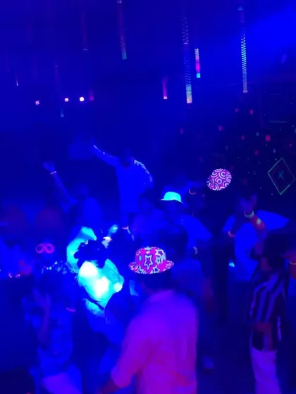 A blacklight party in full effect. The glowing hats and outfits looked awesome.