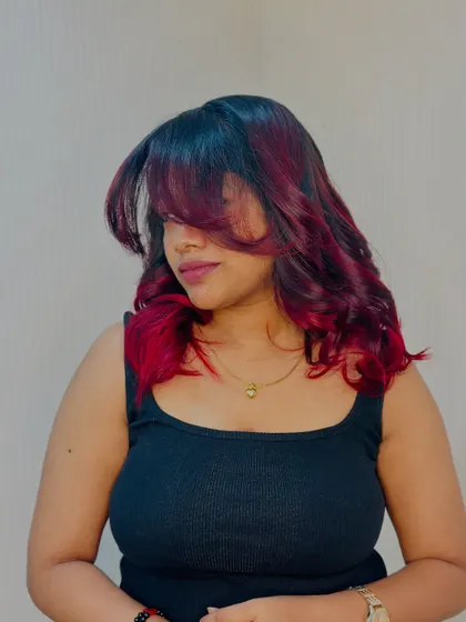 A stylish shot with face framing bangs, this look is all about attitude and bold color.