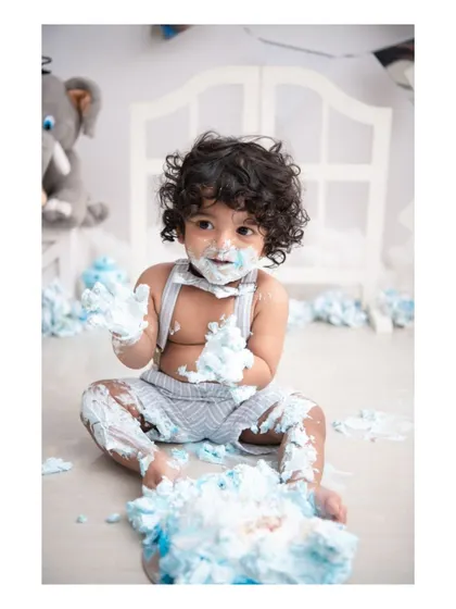 Nothing says 'first birthday' like a fun and messy cake smash! This shot captures the delightful chaos and excitement of a baby's first taste of cake. I handle the entire setup and cleanup, so you can just enjoy the moment.