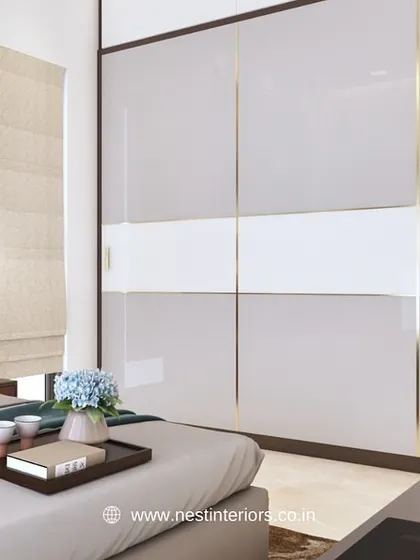 A 3D render of a bedroom with a glossy, two-tone sliding wardrobe. The gold inlay adds a touch of luxury, and the design is planned to be both beautiful and space-efficient.