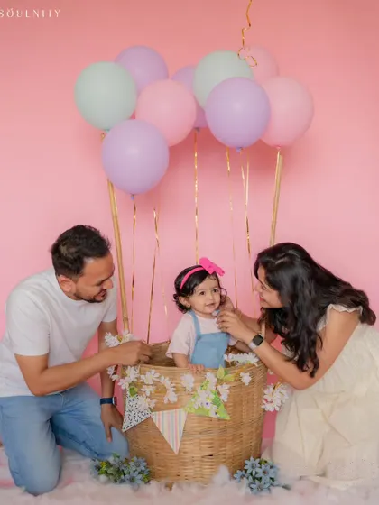 A pastel dream for a first birthday. This hot air balloon setup with soft pinks and purples is perfect for a little princess's celebration.