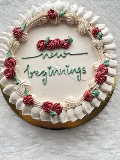 A simple cake with a beautiful message. The vintage-style piping and hand-lettered "new beginnings" make it perfect for celebrating a new chapter in life.