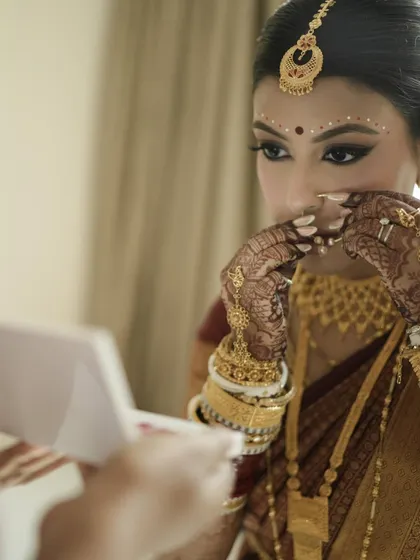 A candid moment of reflection. This shot captures the intricate details of her henna and the traditional bangles.