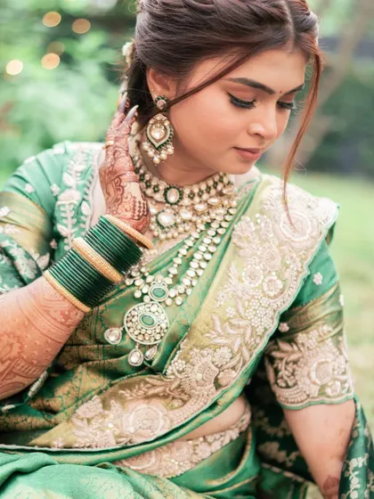 A close-up on the details. The makeup complements the intricate embroidery of the saree and the stunning layered jewelry. The focus is on creating a look of understated elegance.