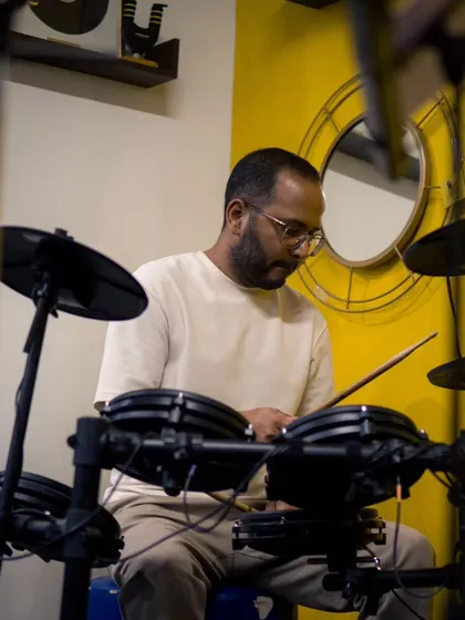The focus and energy of a drummer during a live performance at our studio. These sessions are all about creating unforgettable musical memories.