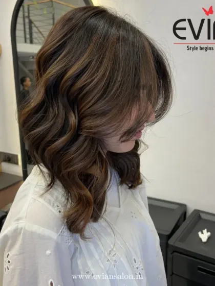 The way the hair falls across her face shows how I cut and color to create a flattering shape. The highlights are placed strategically to add brightness around the face.