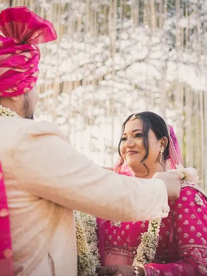 The Varmala exchange between Arjun and Nerrisa, a moment filled with smiles and anticipation.