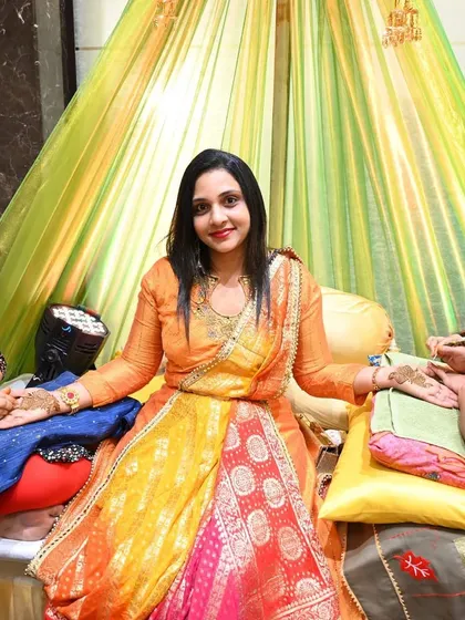 A bride enjoying her Mehendi application. I ensure the seating is comfortable and the setup is beautiful, so she can relax during the hours-long process.