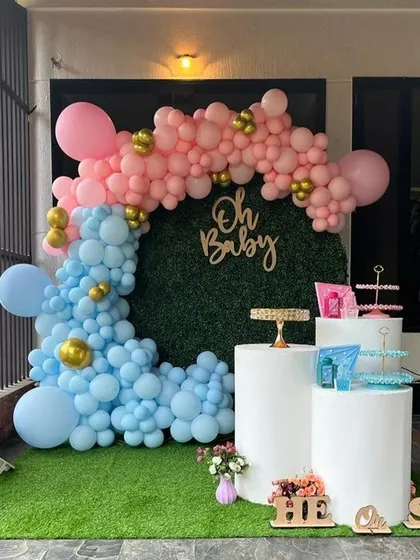 A modern and popular 'He or She' gender reveal party. I used a stylish grass wall backdrop with a pink and blue organic balloon garland to create the perfect photo opportunity for the happy couple.