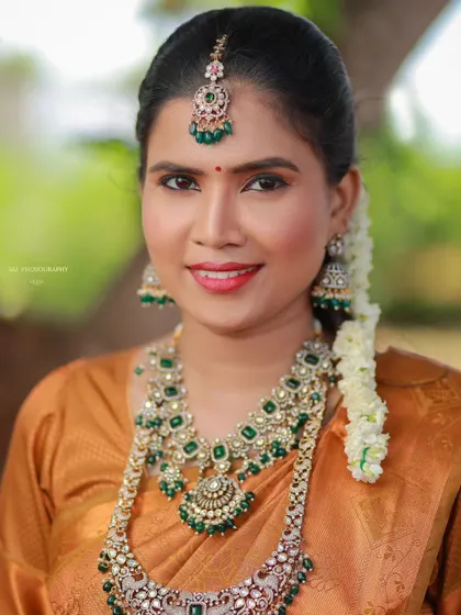A close-up portrait of the model, highlighting the intricate details of the kundan jewellery.