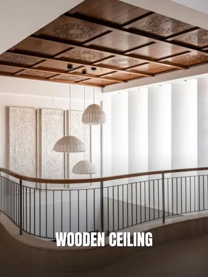 A wooden ceiling brings warmth and texture to a space. This design features intricately carved panels that add a touch of traditional craftsmanship to a modern duplex.