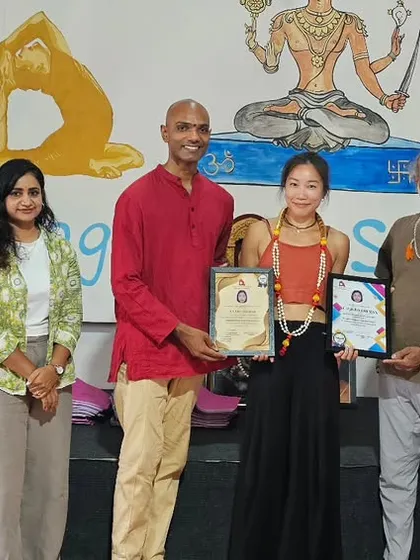 Another proud graduate from the Thailand intensive workshop, holding her certificates for various yoga disciplines.
