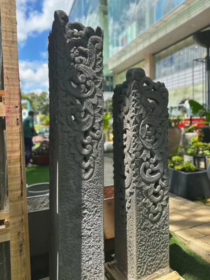 A pair of our hand-carved stone pillars, ready to create a grand and impressive entryway. The deep relief carving catches the light beautifully, highlighting the intricate floral and scroll motifs.