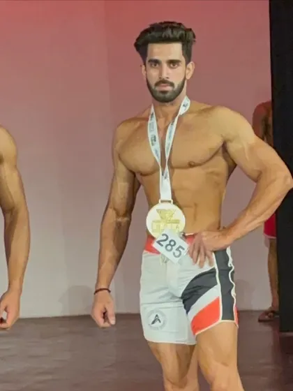 With my second-place medal at Musclemania. Every competition is a chance to learn and improve.