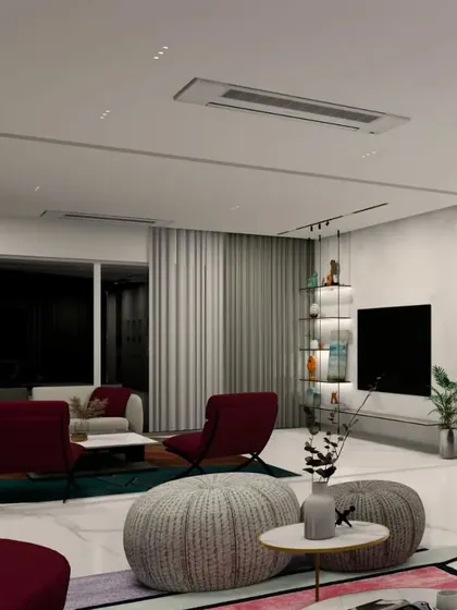 This render for the Gulecha Residence shows an informal living area designed for comfort. Plush, oversized ottomans and deep-seated chairs in rich red tones create a cozy atmosphere for family gatherings and relaxation.