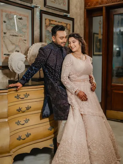 A classic, romantic portrait of a couple during their Sangeet. Their loving gaze and elegant outfits, set against a beautifully decorated interior, create a timeless memory.