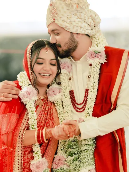 All about love. A tender forehead kiss captures the emotion of the day, with the bride looking effortlessly beautiful.