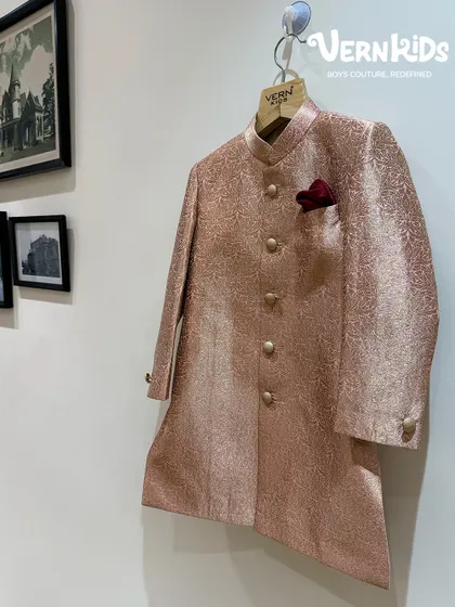 A glimpse of our rose-gold Jodhpuri jacket hanging in the store. The rich, shimmery fabric and classic buttons make this a timeless piece, perfect for creating a mini maharaja look.