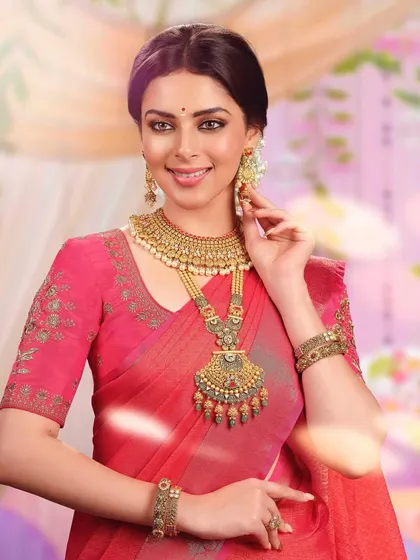 A close-up portrait highlighting another exquisite temple jewelry set. The detailed craftsmanship of the necklace and earrings is the central focus of this bridal look.